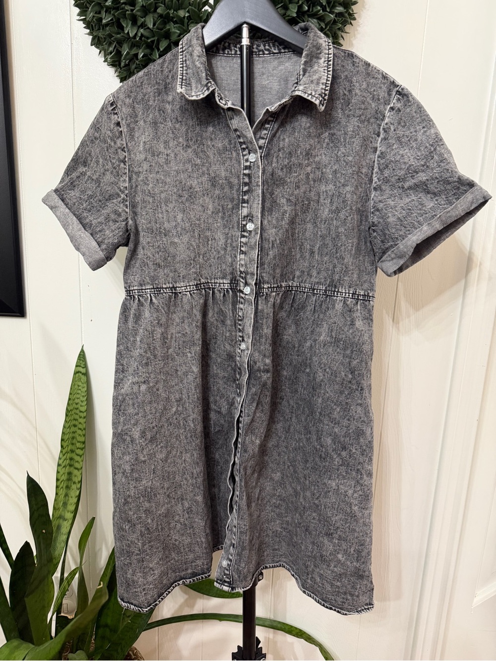Denim dress with rolled sleeves and tiered skirt in the back.